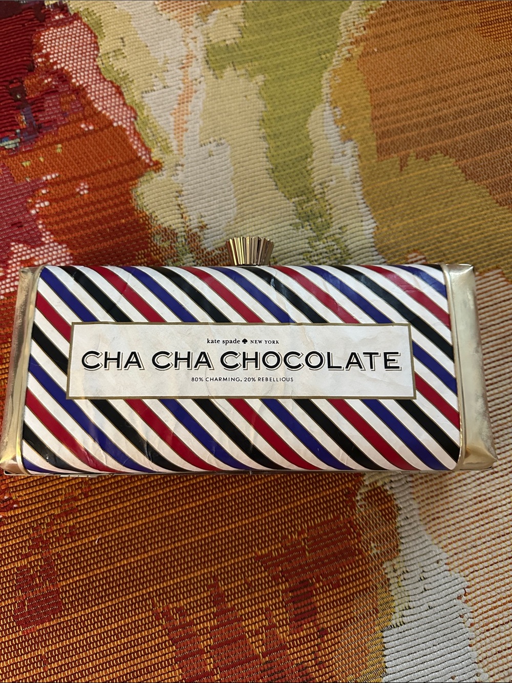 kate spade Cha Cha Chocolate striped clutch in red, blue, black